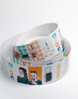 A roll of decorative washi tape with colorful printed illustrations and text, coiled on a plain white background.