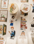 A close-up of decorative tape rolls and strips featuring illustrated library and book-themed scenes on a white background.